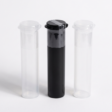 Small tamper-evident shrink bands sealed over the caps of clear and black 73mm vape and pre-roll pop-top tubes